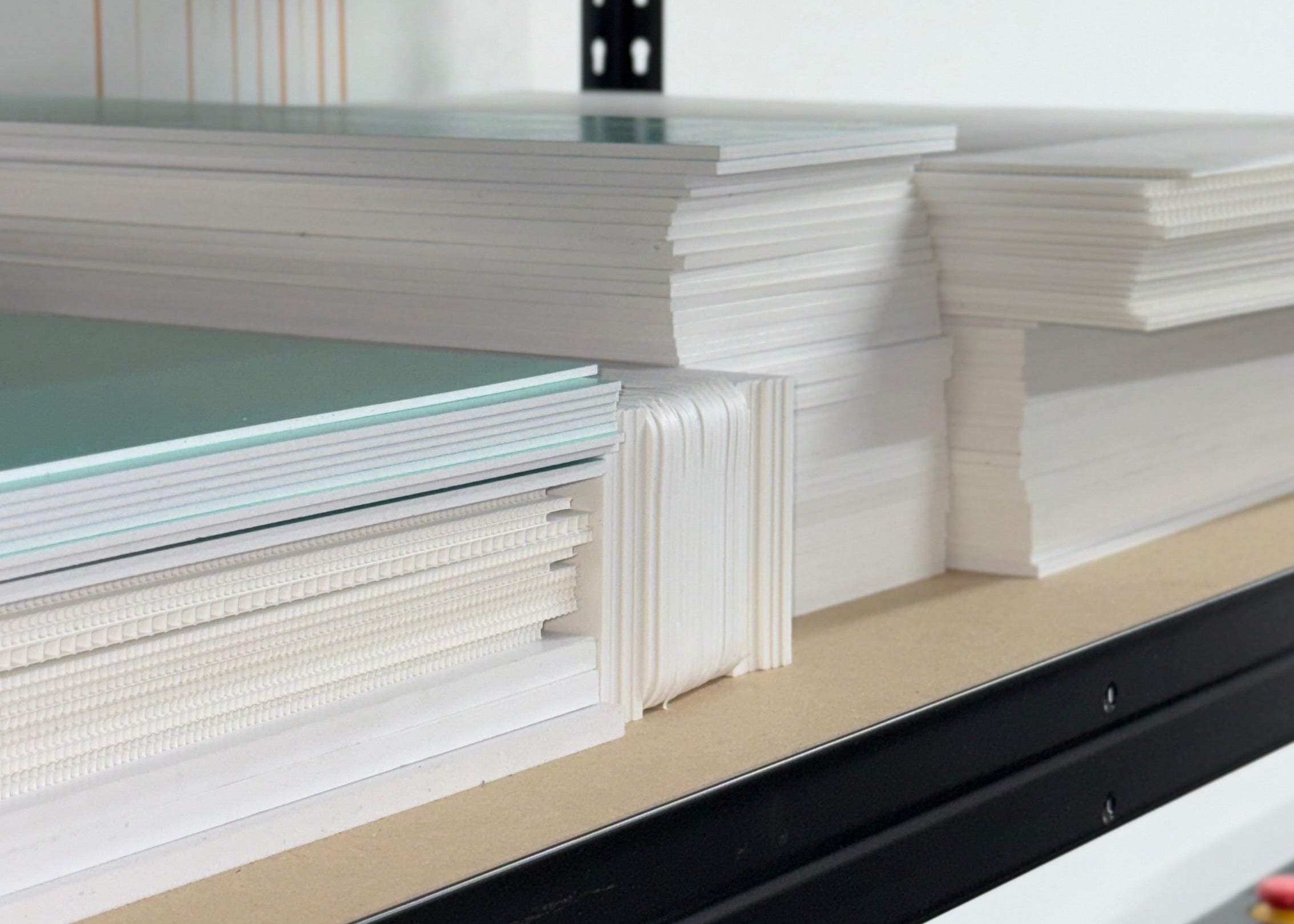 Stacks of foamex, correx and acrylic boards on shelf